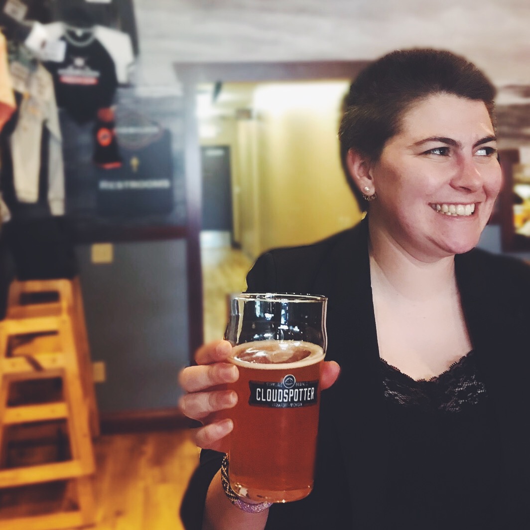 Amy, the author, holding a beer at Stormcloud Brewing Co.